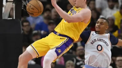 Dalton Knecht, de Los Angeles Lakers, hace un mate ante Keldon Johnson (0), de San Antonio Spurs, durante la segunda mitad de un partido de baloncesto de la NBA, el miércoles 27 de noviembre de 2024, en San Antonio. (Foto AP/Darren Abate)